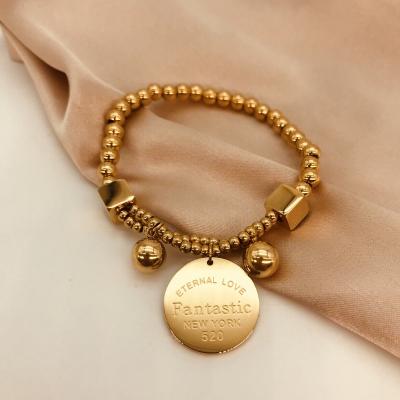 China 18K Real Gold Plated Titanium Steel Handmade Wire Round Bead CLASSIC Elastic Gold Coin Bangle Bracelet for sale