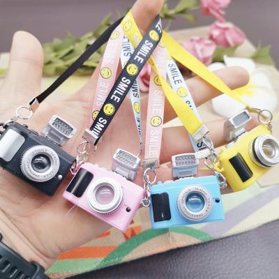 China Decorations and Toys Creative Mini Light Camera Cartoon Plush Doll with Face Strap Flash Camera Toy Smile Hanging Decoration for sale