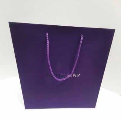 China Recyclable Gift bags purple paper all kraft paper bags boutique bags with handmade purple handles for sale