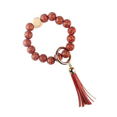 China Wooden Leopard Beads Monogram Key Chain Engrave Bag Pendant Disc Bracelet Tassel Mobile Phone Key Chains for sale