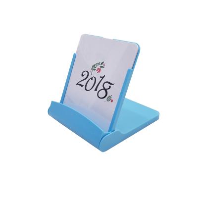 China Multifunctional Folding Desktop Calendar Mobile Phone Holder Stand Desk Calendar for sale