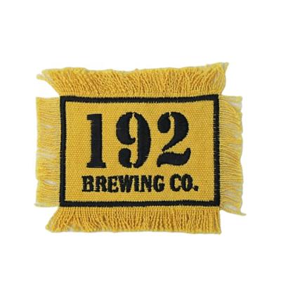 China OEKO-TEX Sustainable Yellow Embroidery Number Patches Woven Label Canvas Badges With Tassels for sale