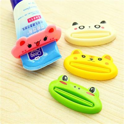 China Easy Rolling Holder Cute Bathroom Toothpaste Dispenser Cartoon Squeezer for sale