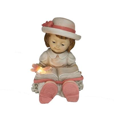 China New Design Traditional Home LED Lamp Resin Nursery Outdoor Solar Decoration Garden Ornaments Read Child Statues Figurine for sale