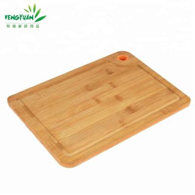 China Viable hot sale bamboo vegetable cutting board with silicone hole for sale