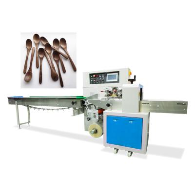 China Horizontal Automatic Wooden Food Flow Packet Machine Spoon Honey Spoon Packing Machine for sale