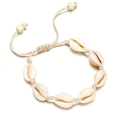 China Hot Sales TRENDY Beach Hawaii Style Handmade Natural Sea Shell Charm Hand Cowrie Shell Waxed Rope Handmade Adjustable Bracelet for sale