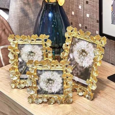 China Classic gold European style apricot leaf metal photo frame 4/6/7 inch photo frame photo frame custom desktop frame for sale