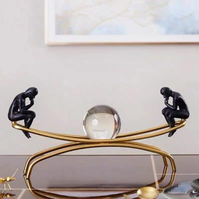 China Modern Luxury Home Decoration Art Metal Bracket Resin Thinker Sculpture Opens Crystal Ball Living Room Table Decoration for sale