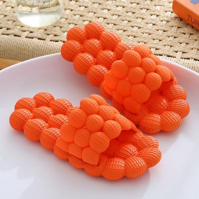 China EVA Orange Bubble Cool Personality Man Fashion Trend Women Massage Home Slippers Trendy Feature Slippers for sale