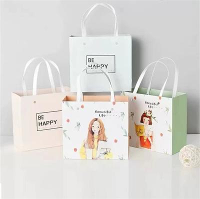 China Custom Manufacturers Recyclable Kraft Paper Apparel Gift Advertising Portable Cartoon Paper Bag for sale