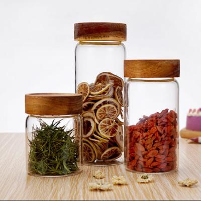 China Borosilicate Glass Candy Jar 200ml 300ml 400ml 500ml Heatable High Capacity Tea Spice Food Storage Jar With Acacia Lid for sale