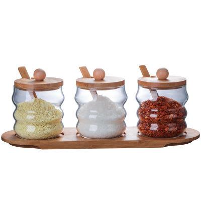 China Sustainable Factory direct sales creative kitchen condiment storage tank glass storage tank with wooden spoon for sale