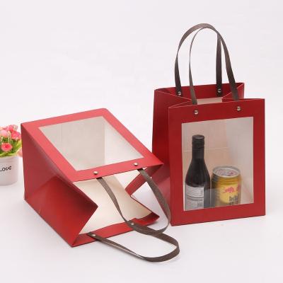 China Recyclable Kraft Paper Gift Bag With Clear Window, Food Storing Ivory Board Wine Paper Bags With Handle for sale