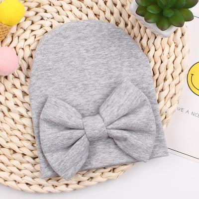 China Soft Warm Cozy Baby Customized Infant Beanie With Simple Hospital Warm Hat 100% Cotton Bow Newborn Hat For Baby Autumn Winter for sale