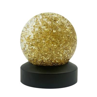 China Europe Diameter 80mm 100mm Water Globe Handmade Silver Aluminum Gold Foil Crystal Ball Resin Base Snow Globe For Home Decoration Gift for sale