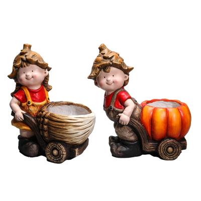 China Traditional Polistone Child Sculpture Resin Boy Girl Pumpkin Kid Statue For Garden Decoration for sale