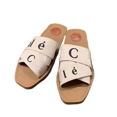 China Lit Slippers Summer Rubber Sandals Beach WOODY FLAT MULE White Black Fashion Canvas Slippers Slippers Canvas Interior Designer Shoe for sale