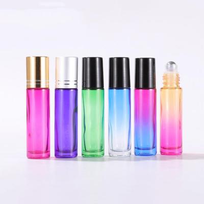 China Cosmetic Wholesale Empty Essential Oil 10ml Clear Amber Blue Glass Roll On Bottle With Metal Trackball for sale