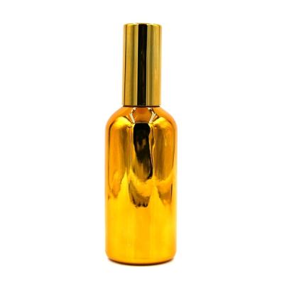 China Personal Care 100ml Gold Color Glass Spray Bottle Luxury Plated Essential Oil Bottle for sale