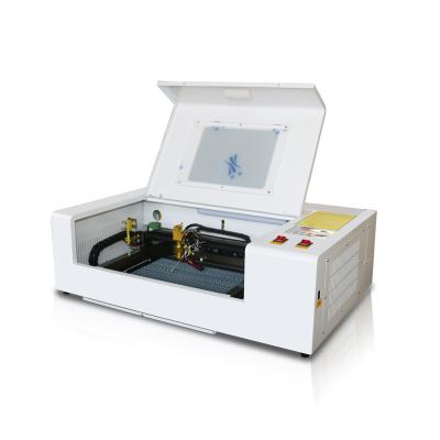 China Small Automated Desktop 3020 Fiber Loading Laser Engraving Cutting Machine Mini Laser Engraver For MDF Wood Acrylic Leather for sale