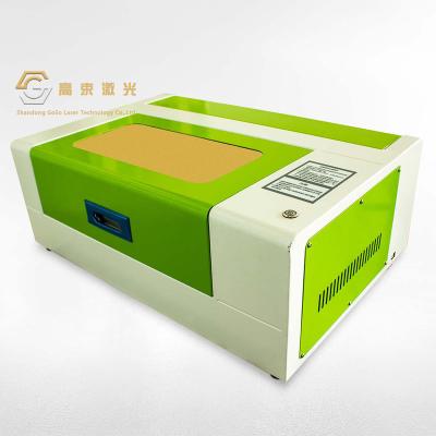 China Automated Loading Laser Engraving Machine 40W CO2 3020 Laser Cutting Machine For Wood Acrylic for sale