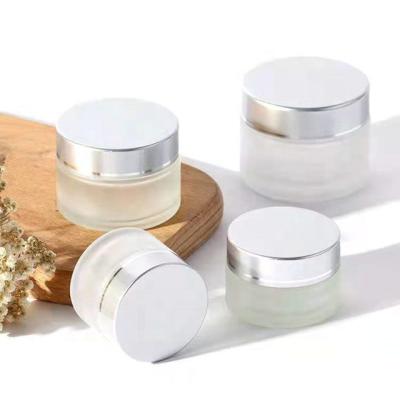 China 50g Cosmetic Jar Empty Cosmetic Glass Jar Packaging Silver Aluminum Lid for sale