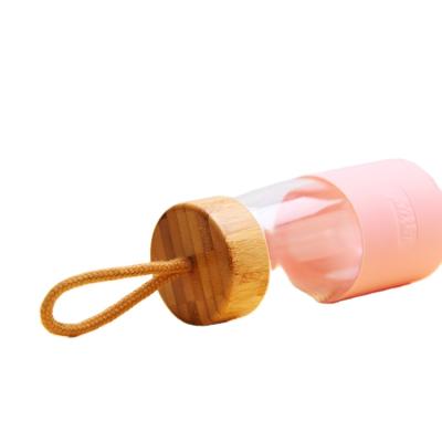 China Eco-friendly factory direct glass water bottle wood lid with rope bottles high quality lids for sale