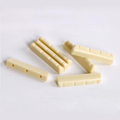 China GUITAR factory wholesale ABS nut and saddle for ukulele plastic material ivory color for sale