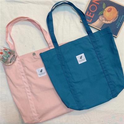 China Eco-Friendly Buckle Tote Bag Large Capacity Handbag Solid Color Literary Women's Shoulder Bag New Retro Women's Small Simple Fresh Canvas Bag for sale