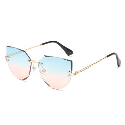 China Cat Eye 2021 New Personality Sharp Red Street Pulling Cut Edge Frameless Cat Eye Sunglasses for sale