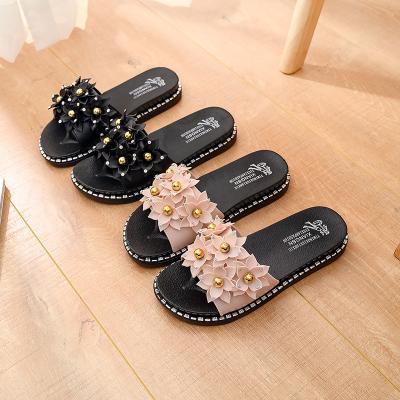 China Anti-slippery most popular ladies personality PVC outsole women soft flat slippers with flower casual sandals for sale