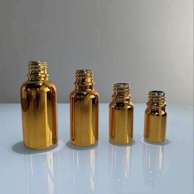 China Wholesale Custom Luxury Glass Gold Plated Bottle Of Daily Life Logo 30ml 50ml Essential Oil Gold Bottle for sale