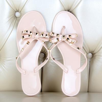 China Fashion Trend Ladies Beach Flip Flops Summer Rivet Bowknot Flip Flops Slippers Brand Women Shoes Flat Sandals for sale