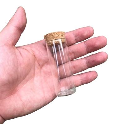 China Gift 27x70x24mm Tiny Glass 25ml Bottle With Cork Transparent Clear Empty Spices Bottles Wholesale Mini Jars Vials Jars Craft for sale