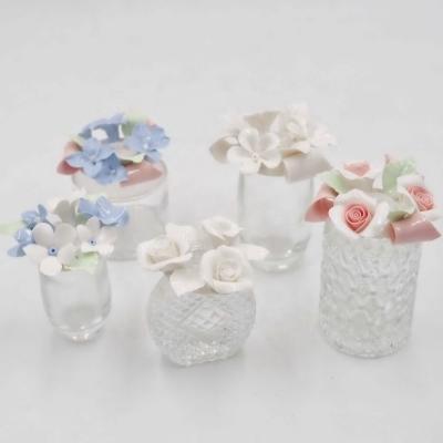 China Gift & The Craft Modern Design Essential Oil Glass Bottle With Handcraft Ceramic Flower Ceramic Perfume Bottle For Home Decoration for sale