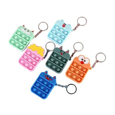 China Hot Selling Bubble Pushing Bubble Sound Fashionable Wiggly Person Key Chain For Kids Custom Soft PVC Silicone Trigger Key Chain With Game Rules for sale