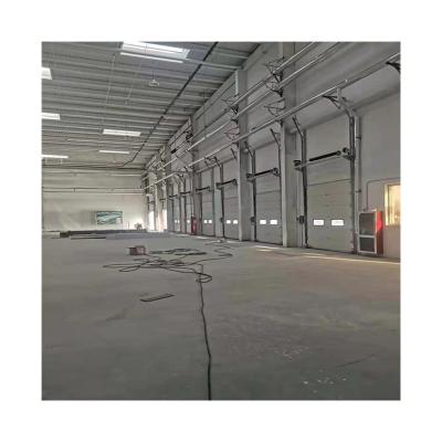 China Waterproof Industrial Auto Home And Abroad Warehouse Loading Dock Thermal Insulated Lift Sectional Door for sale