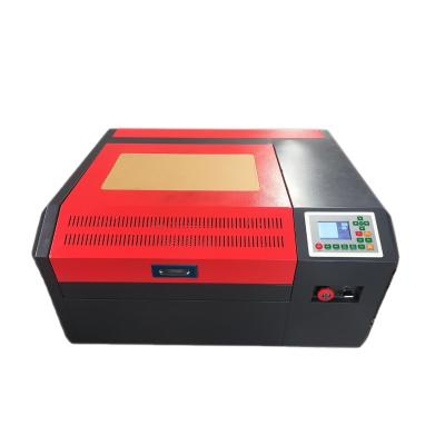 China Portable Laser Engraving 4040 50w 60w Small Paper Acrylic Wine Bottle Laser Engraving Machine Desktop Wood Plastic Engraver for sale