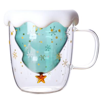 China Morden Luxury Christmas High Borosilicate 300ml Double Wall Glass Coffee Mug Solid Green Heat Resistant Mug With Snow Shape Silicone Lid for sale