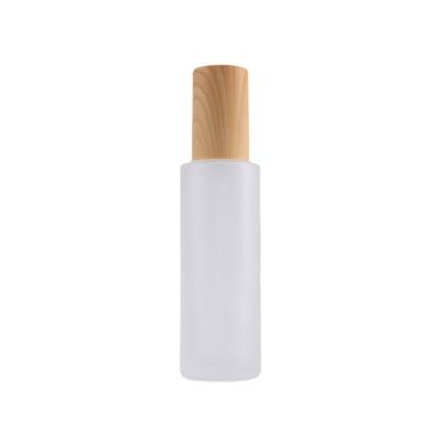 China Personal care; Hot Selling Custom Gift Wooden Lid Portable Pump Sprayer Frosted Glass Bottles For Essential Oil Bottle for sale