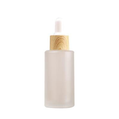 China Personal care; New Cover Cosmetics Gift Cover Portable Wooden Bottle Custom Packaing Frosted Glass Pump Sprayer Essential Oil Bottle for sale