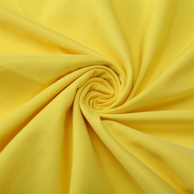 China Stock Poly Memory Polyester Fabric Waterproof Yellow Imitation Fabric Fabric For Dress Lining Clothes for sale