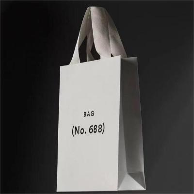 China Luxury Recycled Materials Ribbon Handle Boutique Shopping Packaging Customized Printed Tote Paper Gift Bags With Handle for sale