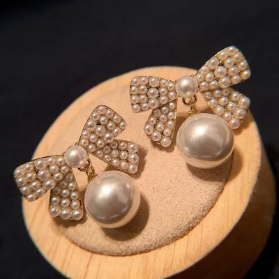 China Fashionable Sweet Korean Bow Earrings Super Fairy Jewelry Brass Gold Plated Imitation Pearl Earrings Girl for sale