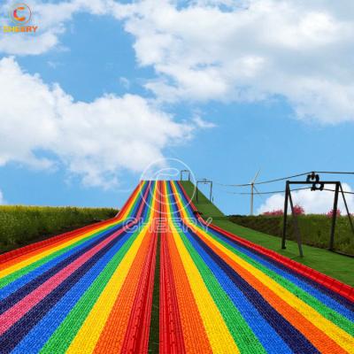 China PP Cheerful Amusement One-Stop Service Amusement Park No Base Rainbow Slide Plastic Grass Slide for sale