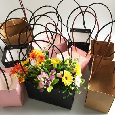 China Disposable Floral Presents Flower Handbag Gift Boxes Floral Kraft Paper Bag With Long Handles Gift Paper Bags for sale