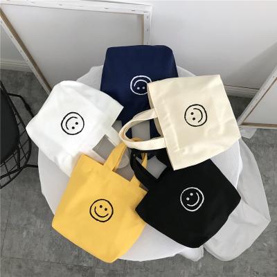 China Cute Smile Face Hand Fashion Bento Bag Parent-child Environmentally Friendly Breakfast Bag Carry Handbag for sale