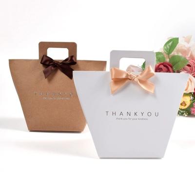 China 2022 Hot High Quality Recycled Materials Trapezium Gold Foil Best Cheap Paper Bag With Handle Ribbon for sale