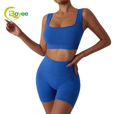 China Breathable 2 Piece Custom Yoga Gym Set Women Solid Color Sports Yoga Bra Set Fitness Seamless Yoga Ribbed Shorts Set for sale